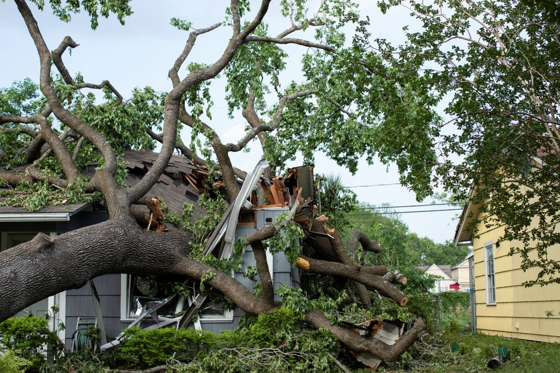 A house is damaged by a tree after a severe storm in Houston, on May 18. Texas homeowners saw their insurance rates rise by more than 23% in 2023, according to S&P Global.