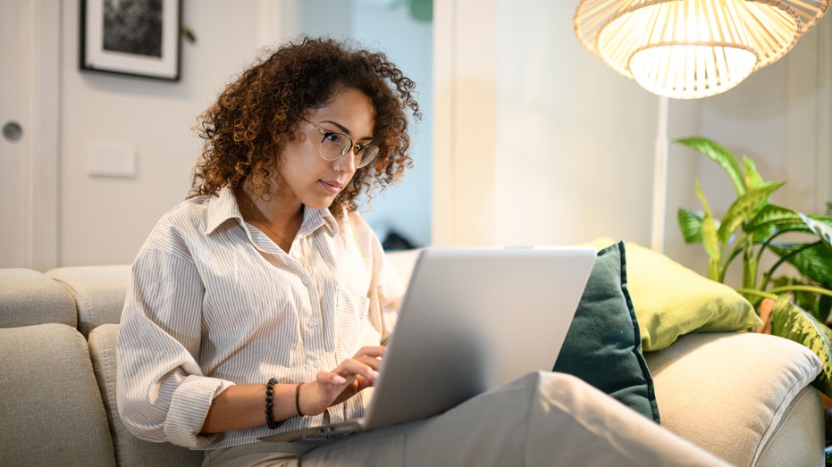 Woman working on her laptop at home